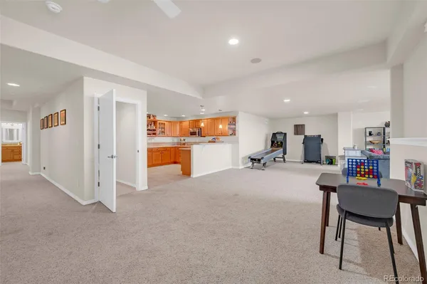 a living room with furniture and a dining table with kitchen view