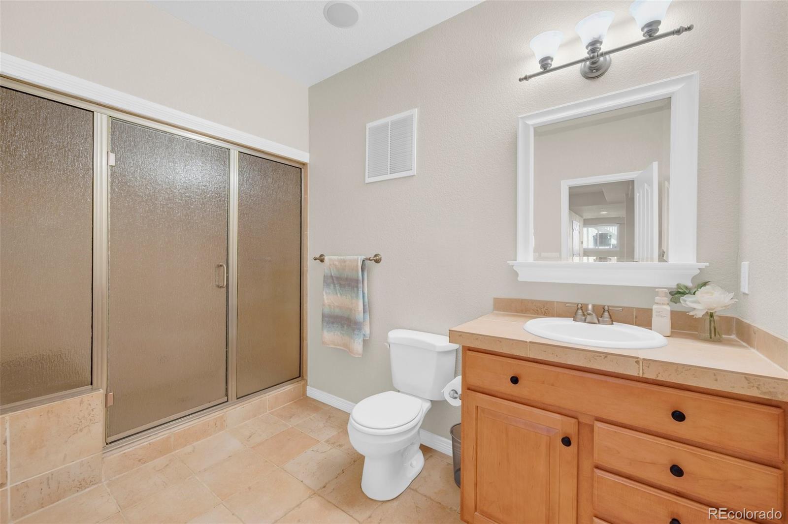 2382 Antelope Ridge Trail Parker, CO 80138 - Photo 44 of 49 a bathroom with a toilet sink and shower