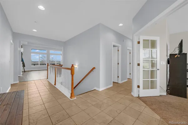 a view of a hallway with a furniture and a refrigerator