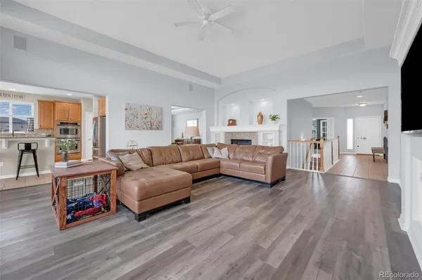 a living room with furniture and a wooden floor
