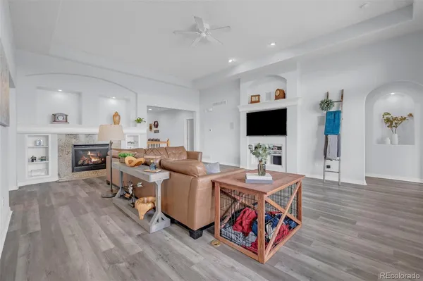a living room with fireplace furniture and a flat screen tv