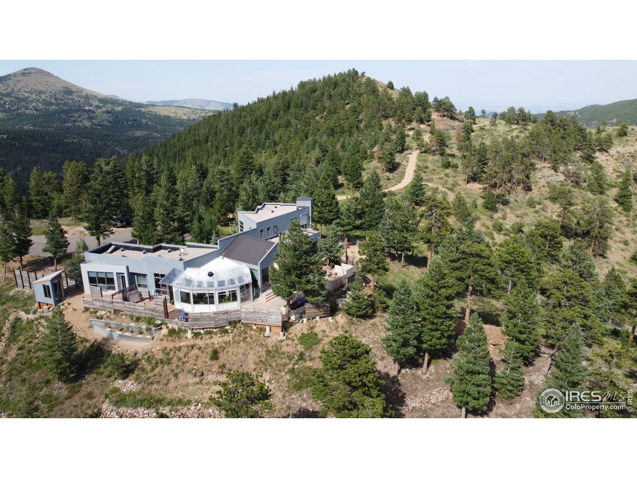 4659 Ridge Road Boulder, CO 80302 - Photo 1 of 7 a view of a house with a mountain in the background