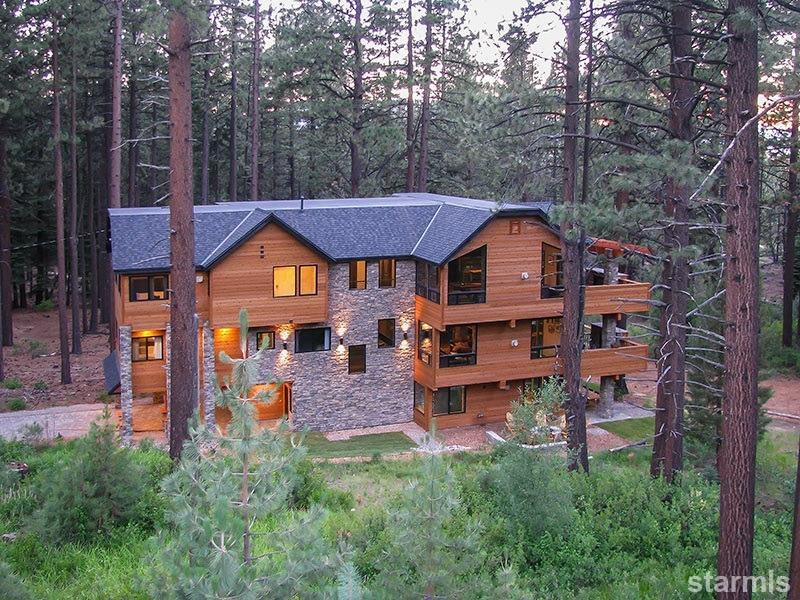 3739 Saddle Road South Lake Tahoe, CA 96150 - Photo 1 of 25 a front view of a house with garden and trees
