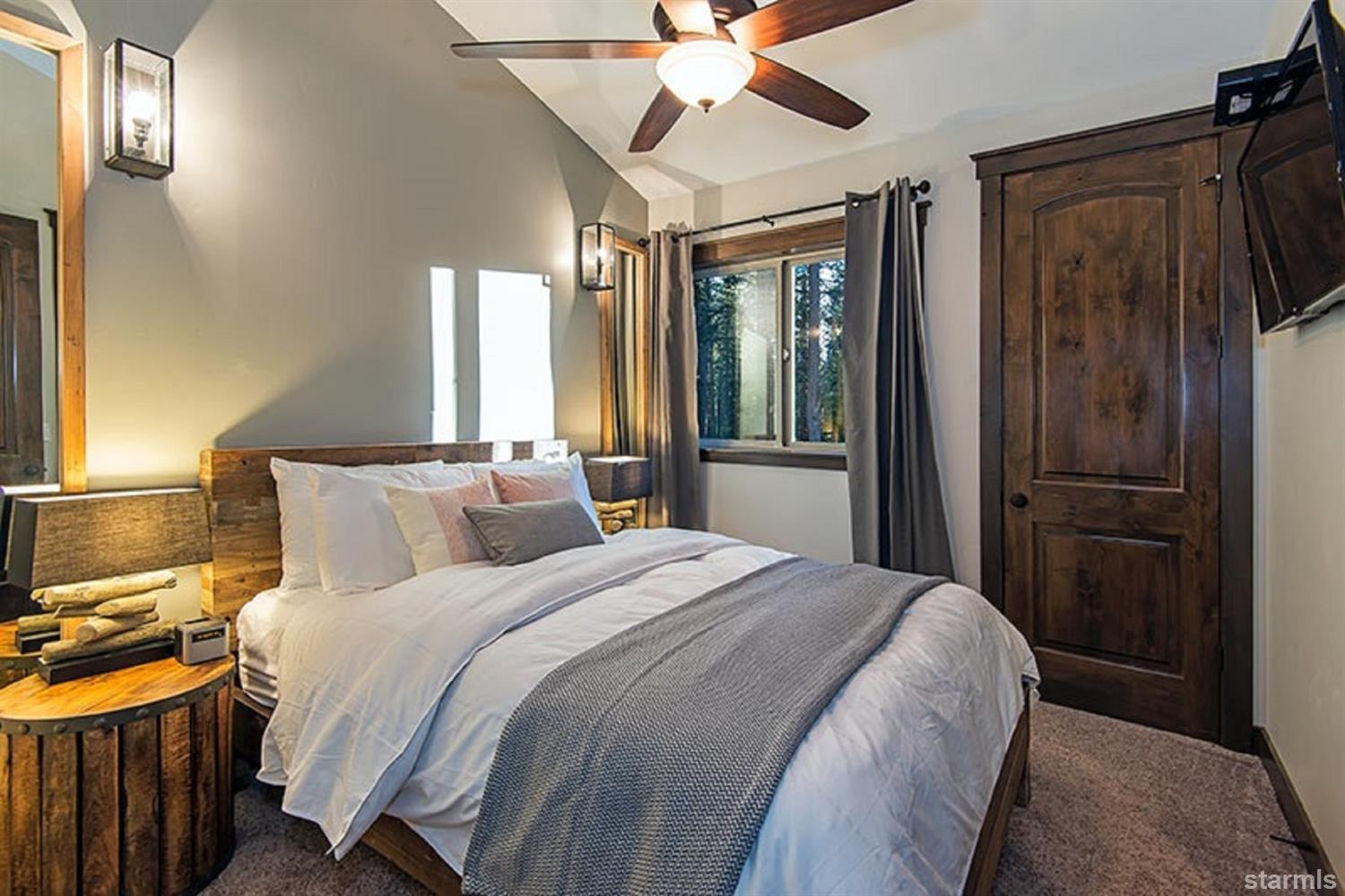 3739 Saddle Road South Lake Tahoe, CA 96150 - Photo 17 of 25 a bedroom with a bed and a chandelier