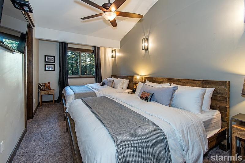 3739 Saddle Road South Lake Tahoe, CA 96150 - Photo 19 of 25 a bedroom with a bed and a chandelier