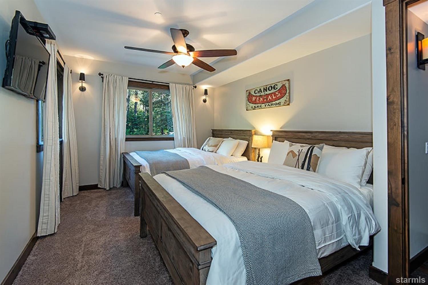 3739 Saddle Road South Lake Tahoe, CA 96150 - Photo 21 of 25 a bedroom with a bed and a chandelier