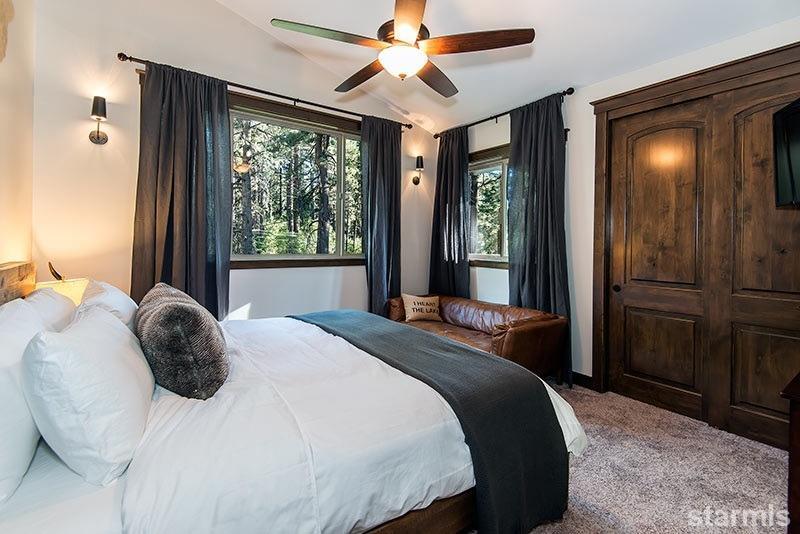 3739 Saddle Road South Lake Tahoe, CA 96150 - Photo 23 of 25 a bedroom with a large bed and a chandelier