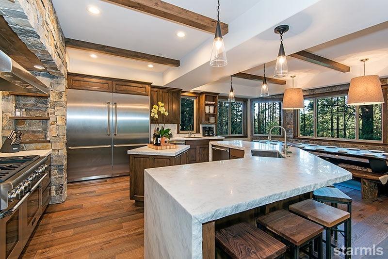 3739 Saddle Road South Lake Tahoe, CA 96150 - Photo 4 of 25 a kitchen with stainless steel appliances a dining table chairs with wooden floor