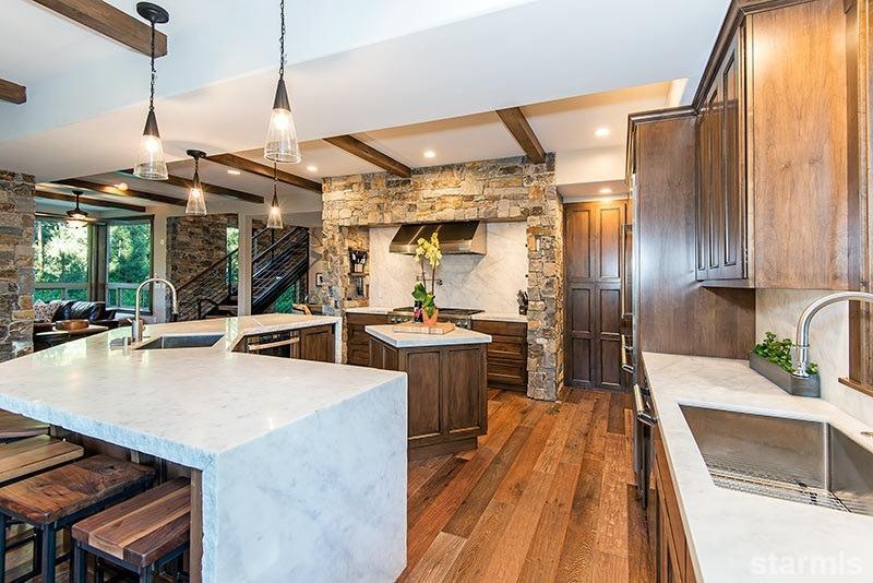 3739 Saddle Road South Lake Tahoe, CA 96150 - Photo 5 of 25 view of a kitchen with kitchen island a large counter top space a sink stainless steel appliances and cabinets