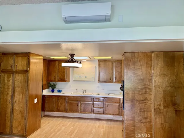 a kitchen with stainless steel appliances a refrigerator and wooden floor