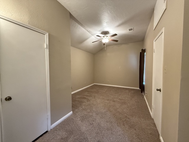 1809 Whitney Way Austin, TX 78741 - Photo 11 of 25 Primary bedroom with vaulted ceiling, ceiling fan, and window to fill the space with abundant natural light.