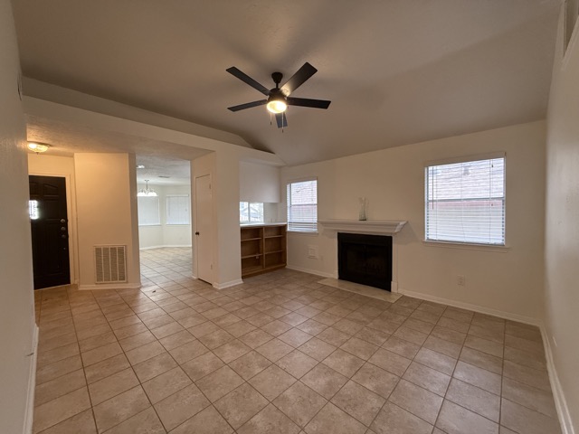 1809 Whitney Way Austin, TX 78741 - Photo 4 of 25 The living room features a cozy fireplace, and built-in shelving that adds warmth, function, and character.