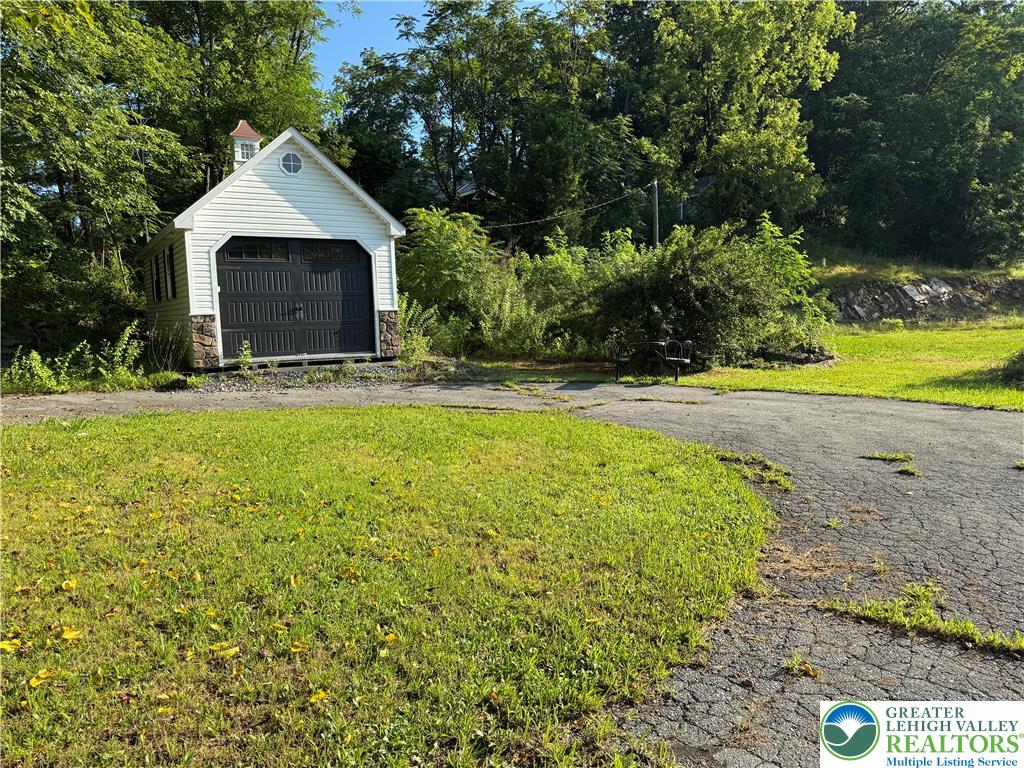 1212 3rd Street Palmerton, PA 18071 - Photo 4 of 5 a front view of a house with a yard and garage