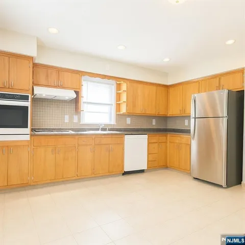 a kitchen with a refrigerator a microwave and sink