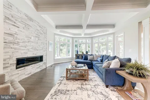 a living room with furniture large window and a fireplace
