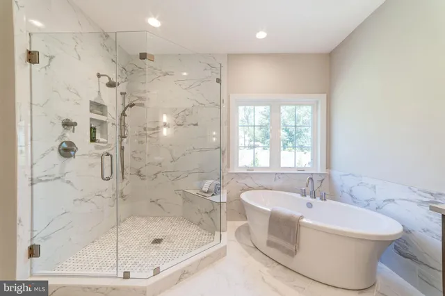 a bathroom with a bathtub and a shower