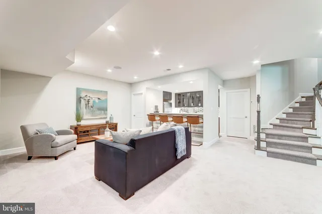 a living room with furniture and a view of kitchen