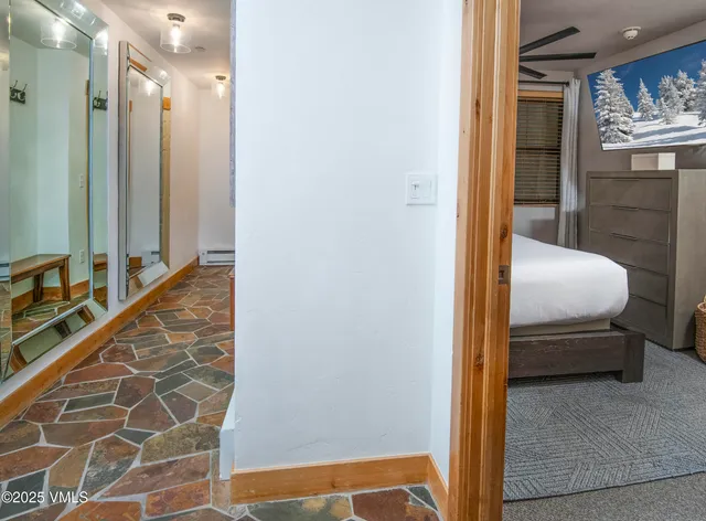 a bedroom with a bed and a mirror