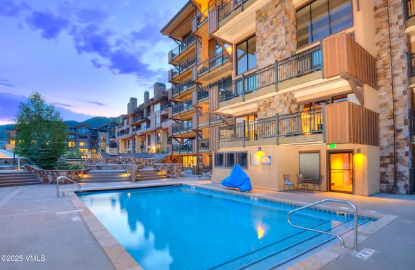 a view of building with swimming pool outdoor seating