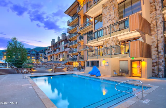 a view of building with swimming pool outdoor seating