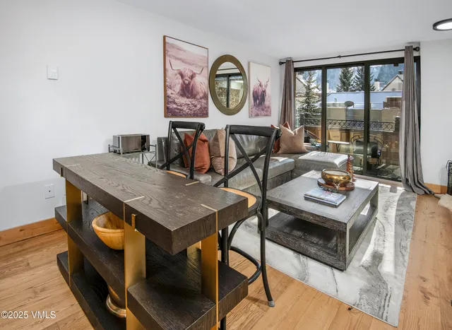 a living room with furniture a table and a large window