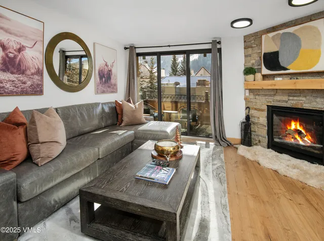 a living room with furniture and a fireplace