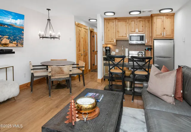 a living room with furniture a flat screen tv and a table