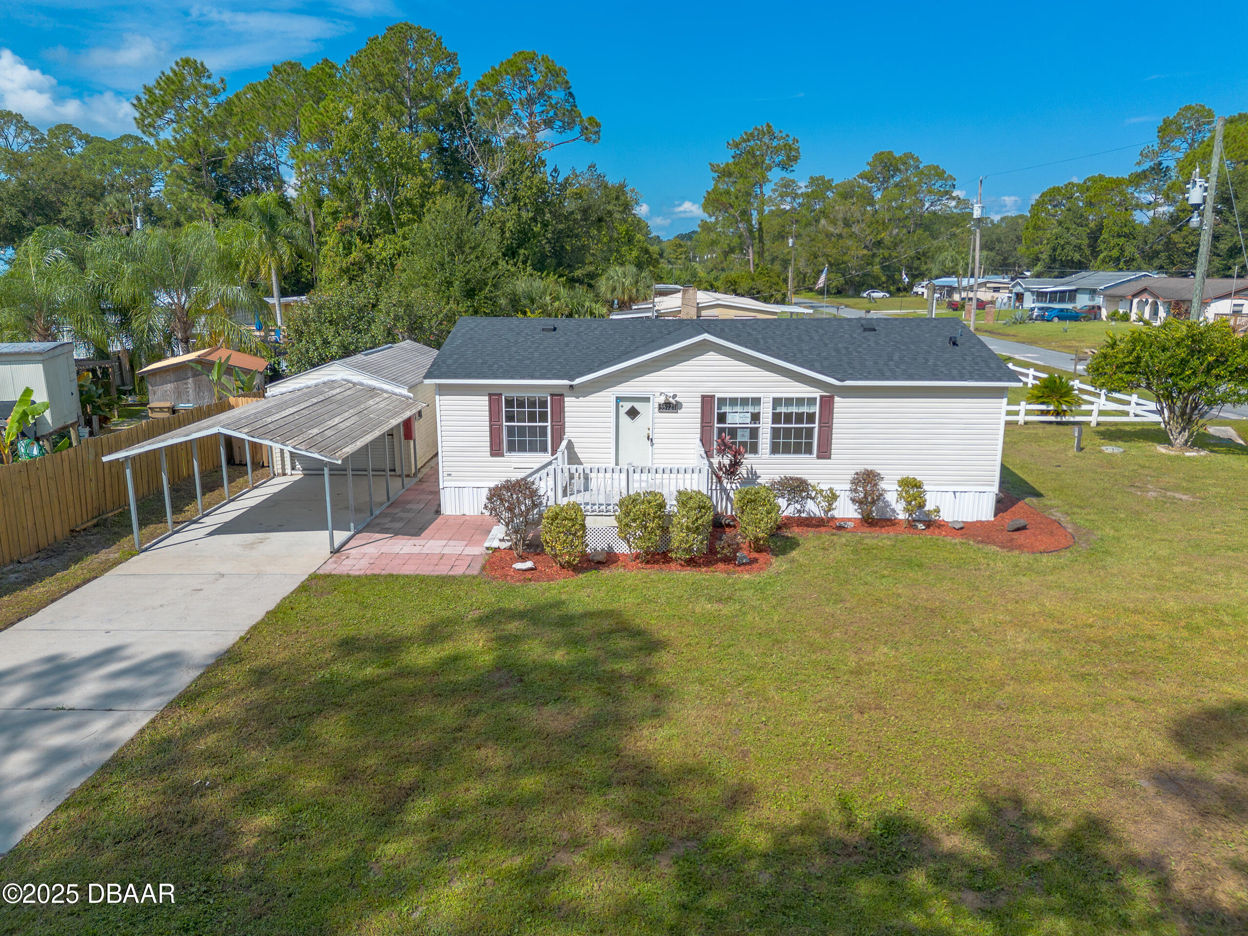 55721 Palmetto Road Astor, FL 32102 - Photo 1 of 27 a front view of a house with a garden