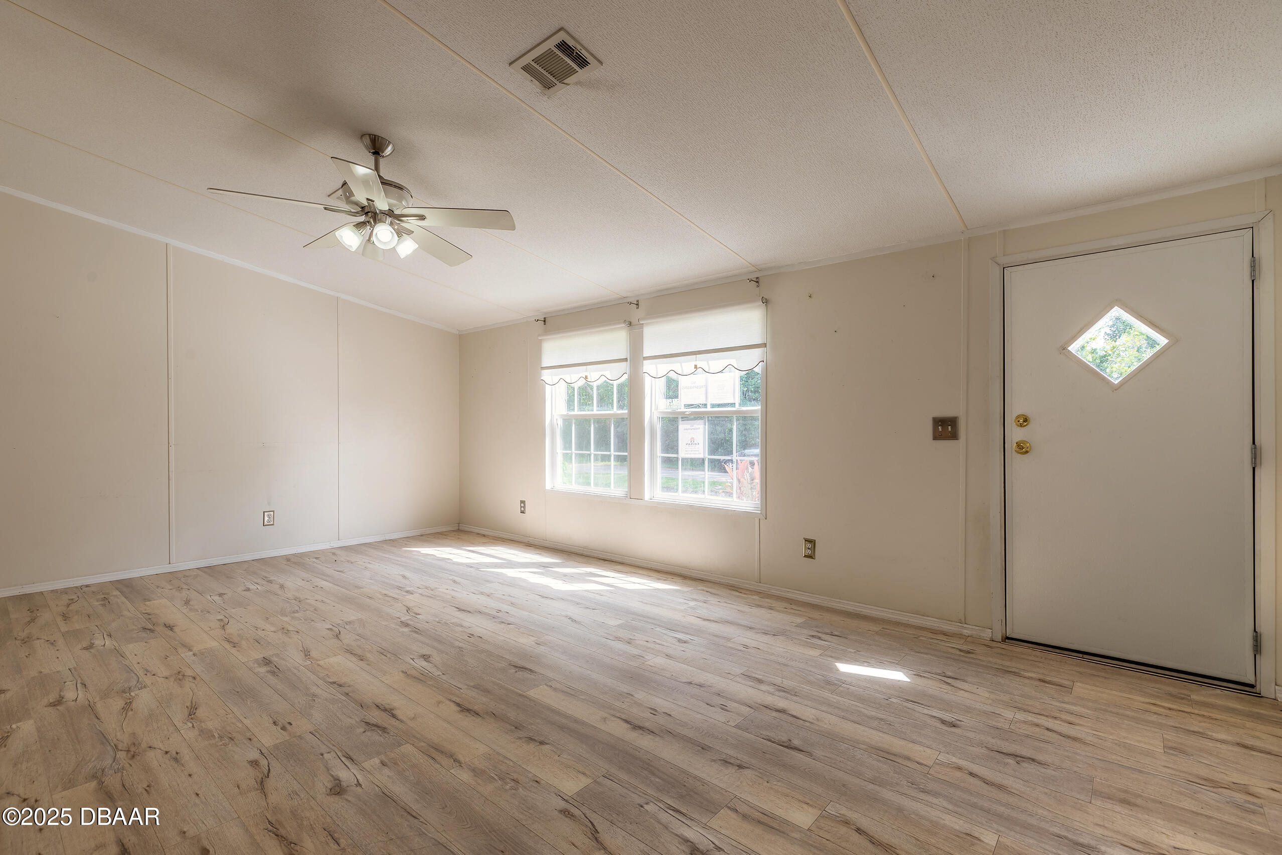 55721 Palmetto Road Astor, FL 32102 - Photo 11 of 27 a view of empty room with wooden floor and fan
