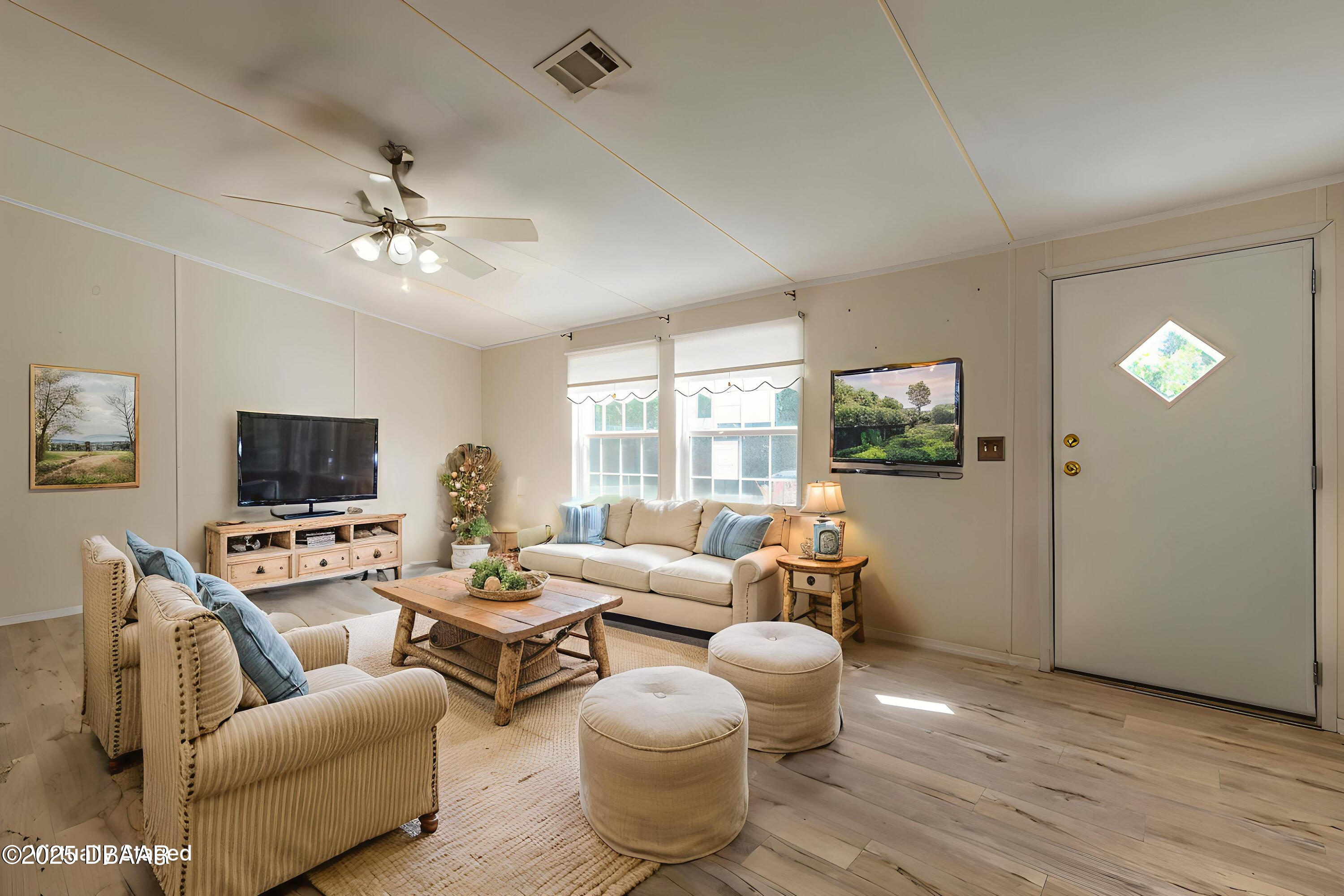 55721 Palmetto Road Astor, FL 32102 - Photo 12 of 27 a living room with furniture and a flat screen tv