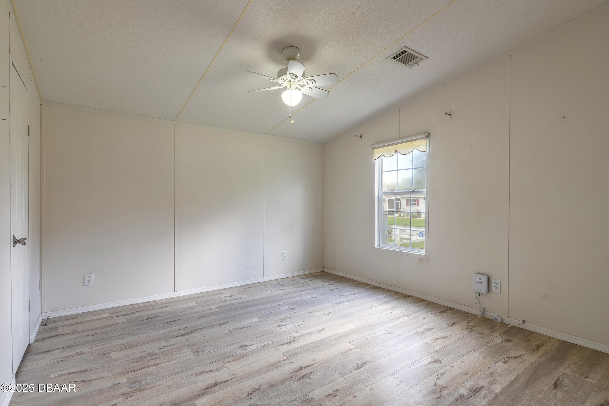 55721 Palmetto Road Astor, FL 32102 - Photo 19 of 27 wooden floor in an empty room with a window