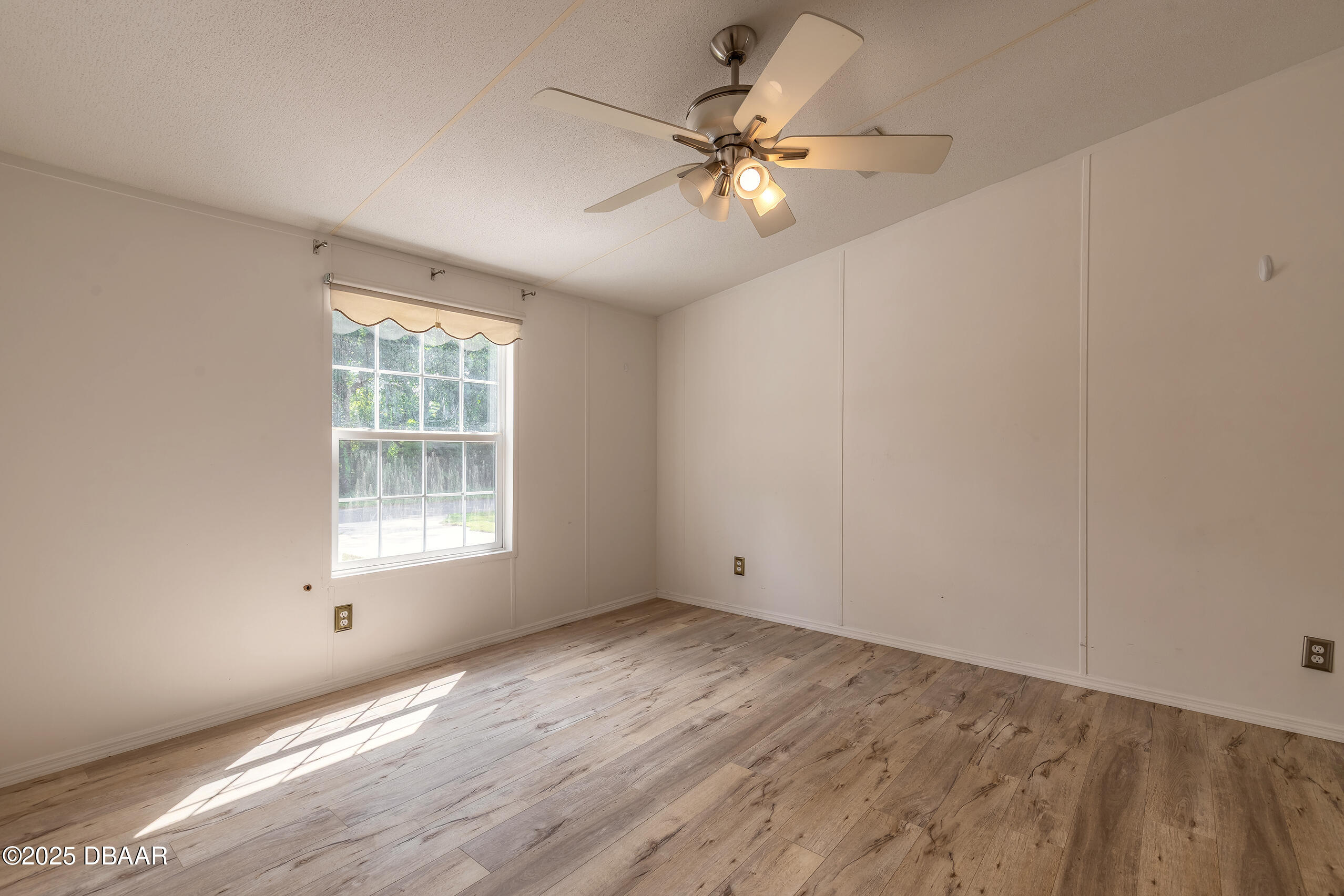 55721 Palmetto Road Astor, FL 32102 - Photo 23 of 27 an empty room with wooden floor and windows