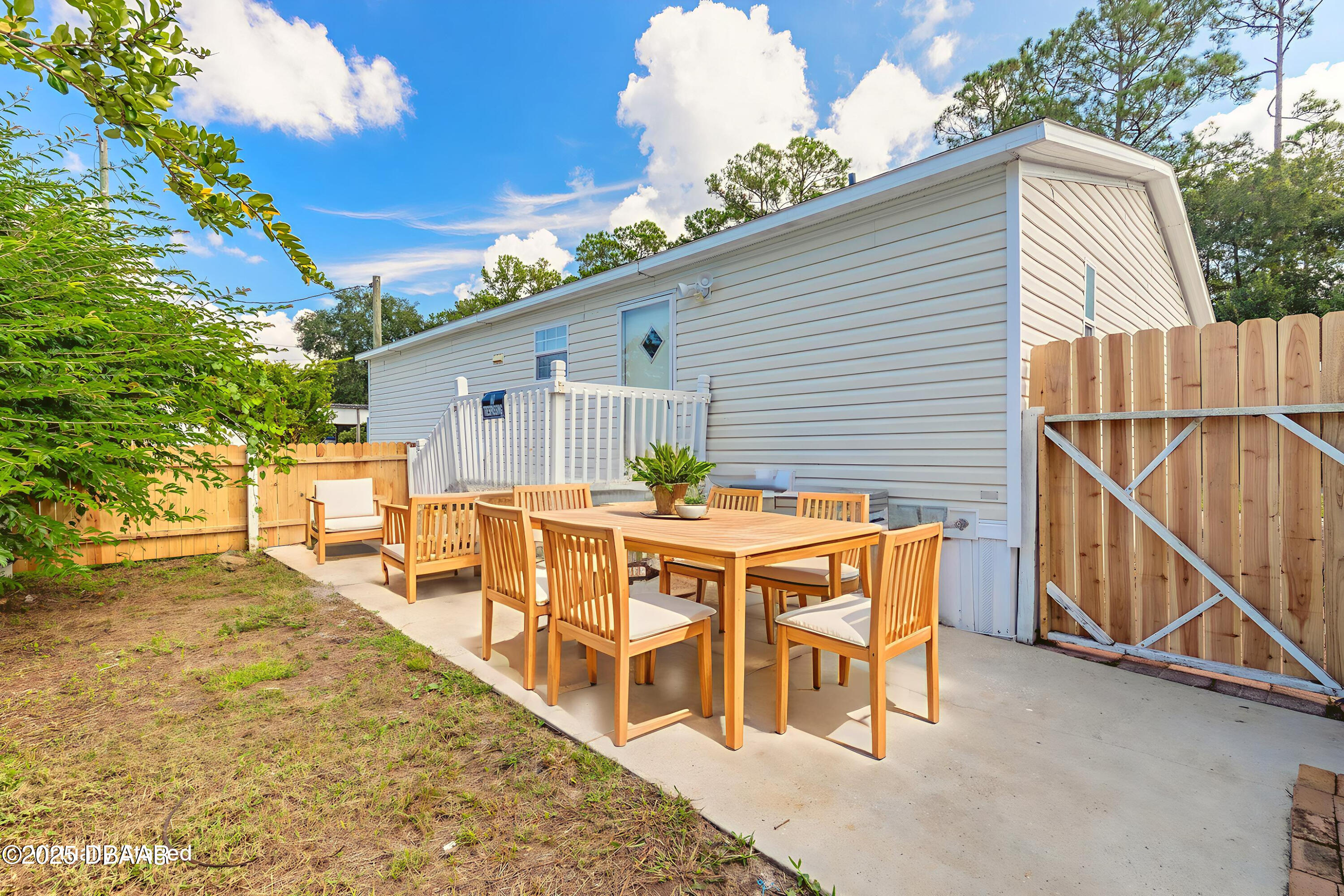 55721 Palmetto Road Astor, FL 32102 - Photo 8 of 27 a backyard of a house with table and chairs
