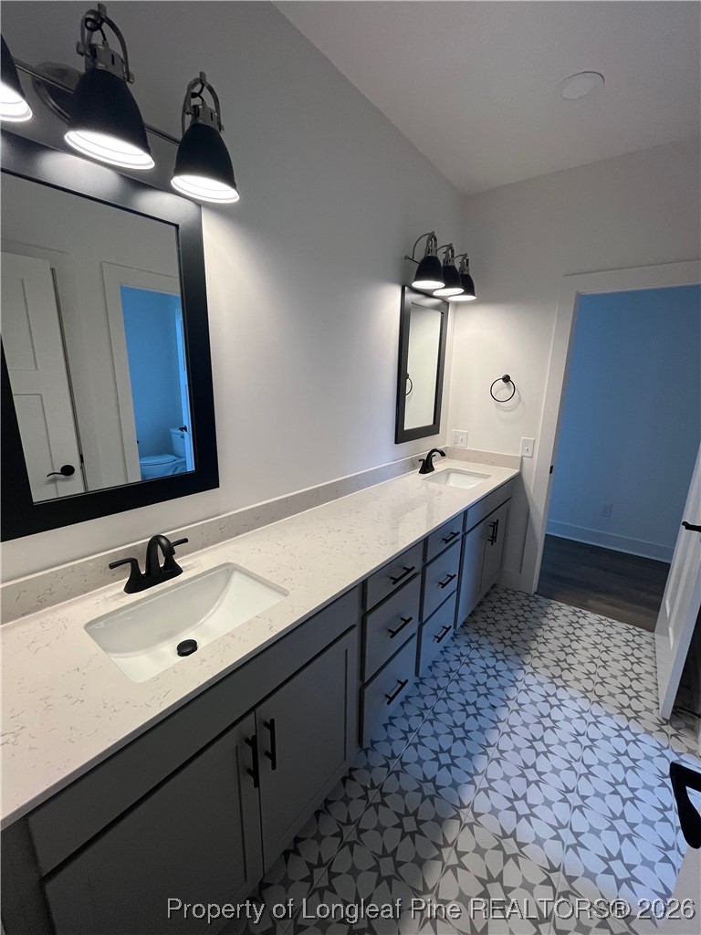 115 Keyser Street Aberdeen, NC 28315 - Photo 10 of 17 a spacious bathroom with a double vanity sink and mirror