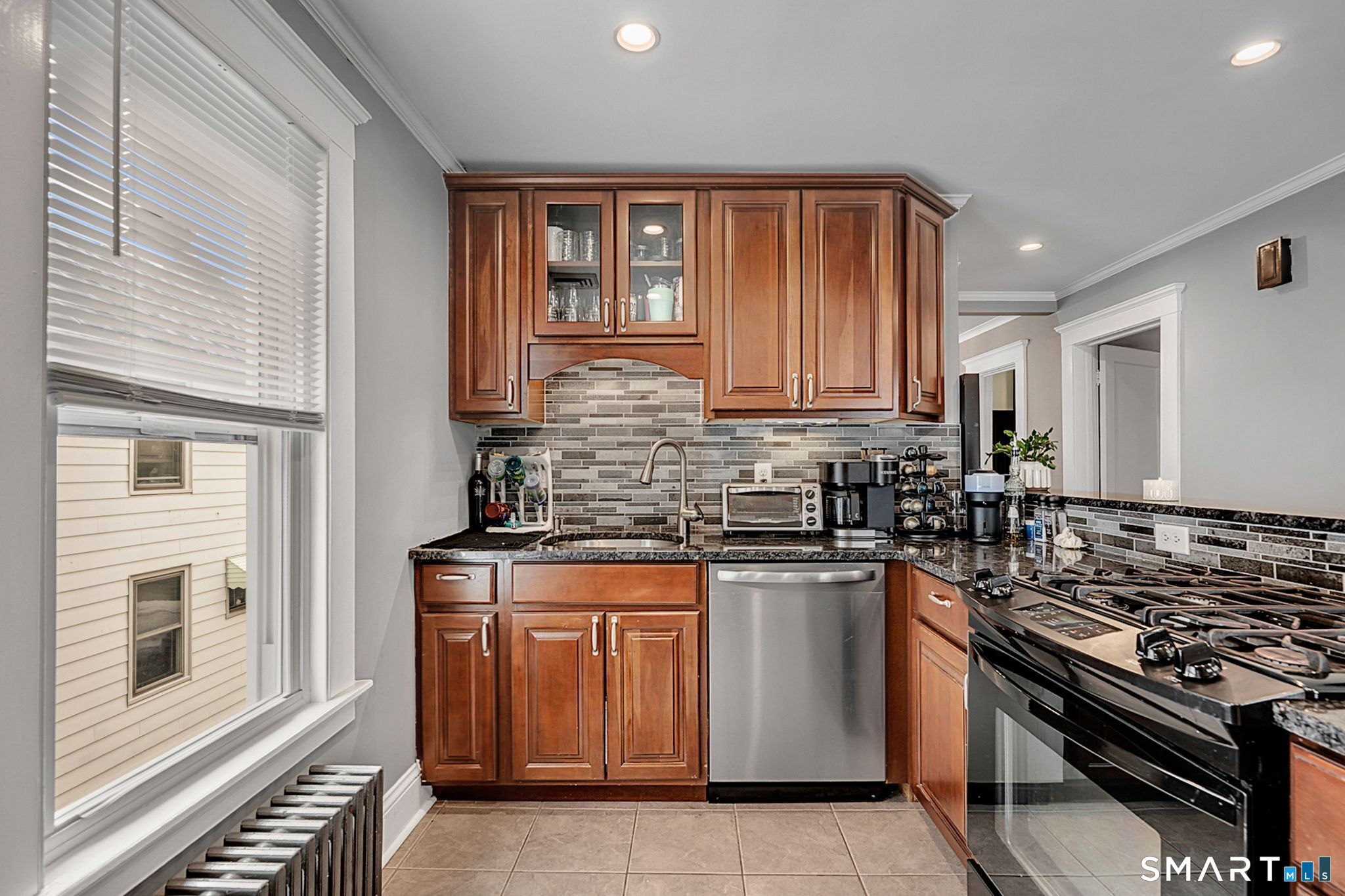 64 Cooper Street Torrington, CT 06790 - Photo 12 of 26 a kitchen with stainless steel appliances granite countertop a stove and a sink
