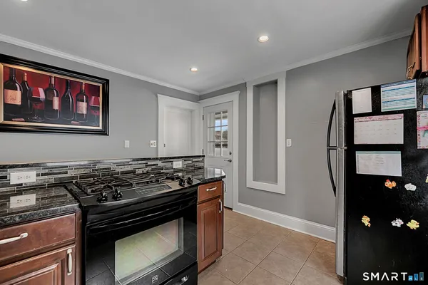 a kitchen with stainless steel appliances granite countertop a stove and a refrigerator