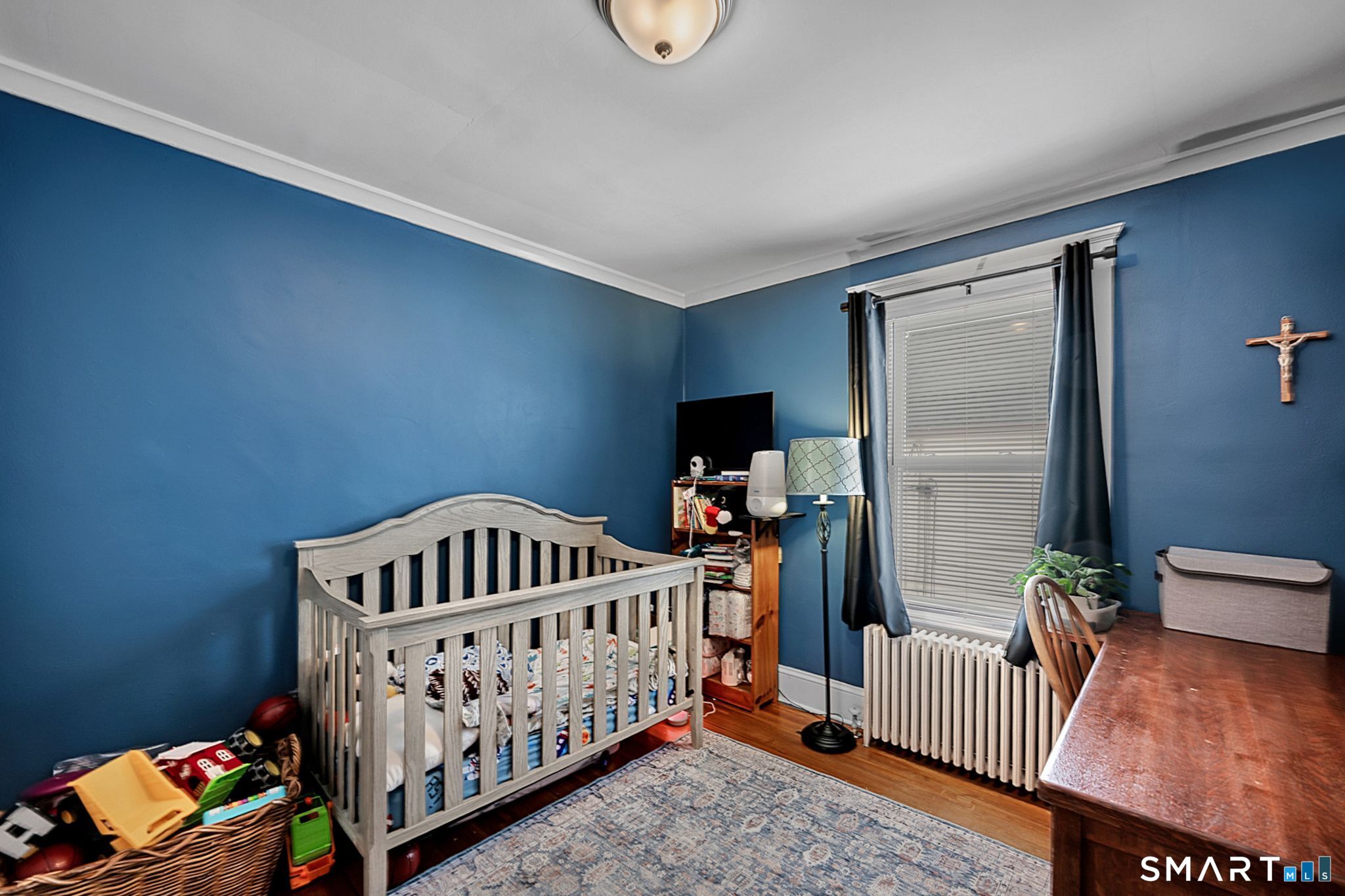 64 Cooper Street Torrington, CT 06790 - Photo 16 of 26 a bedroom with furniture and a baby crib