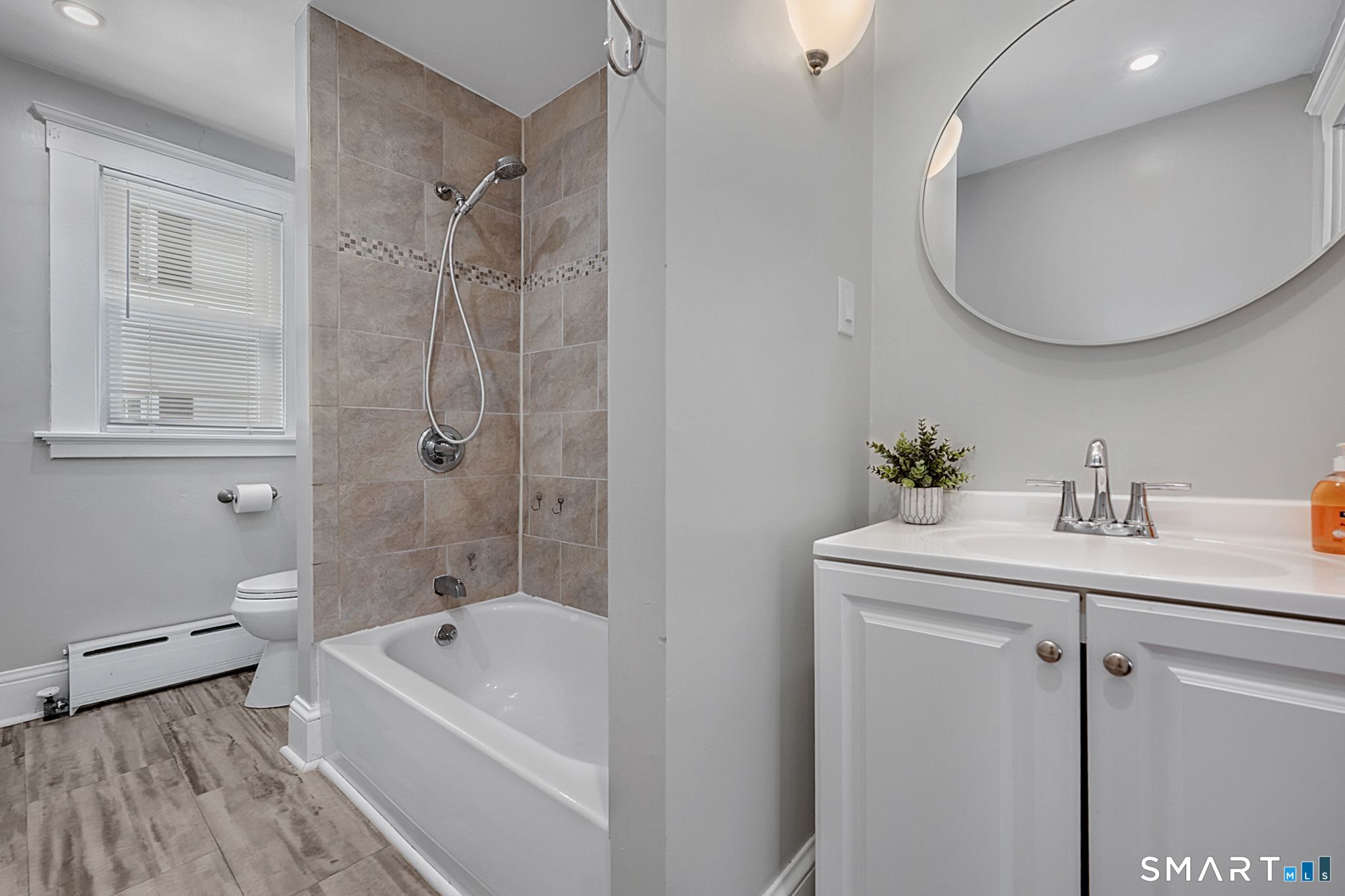 64 Cooper Street Torrington, CT 06790 - Photo 21 of 26 a bathroom with a tub sink toilet and mirror