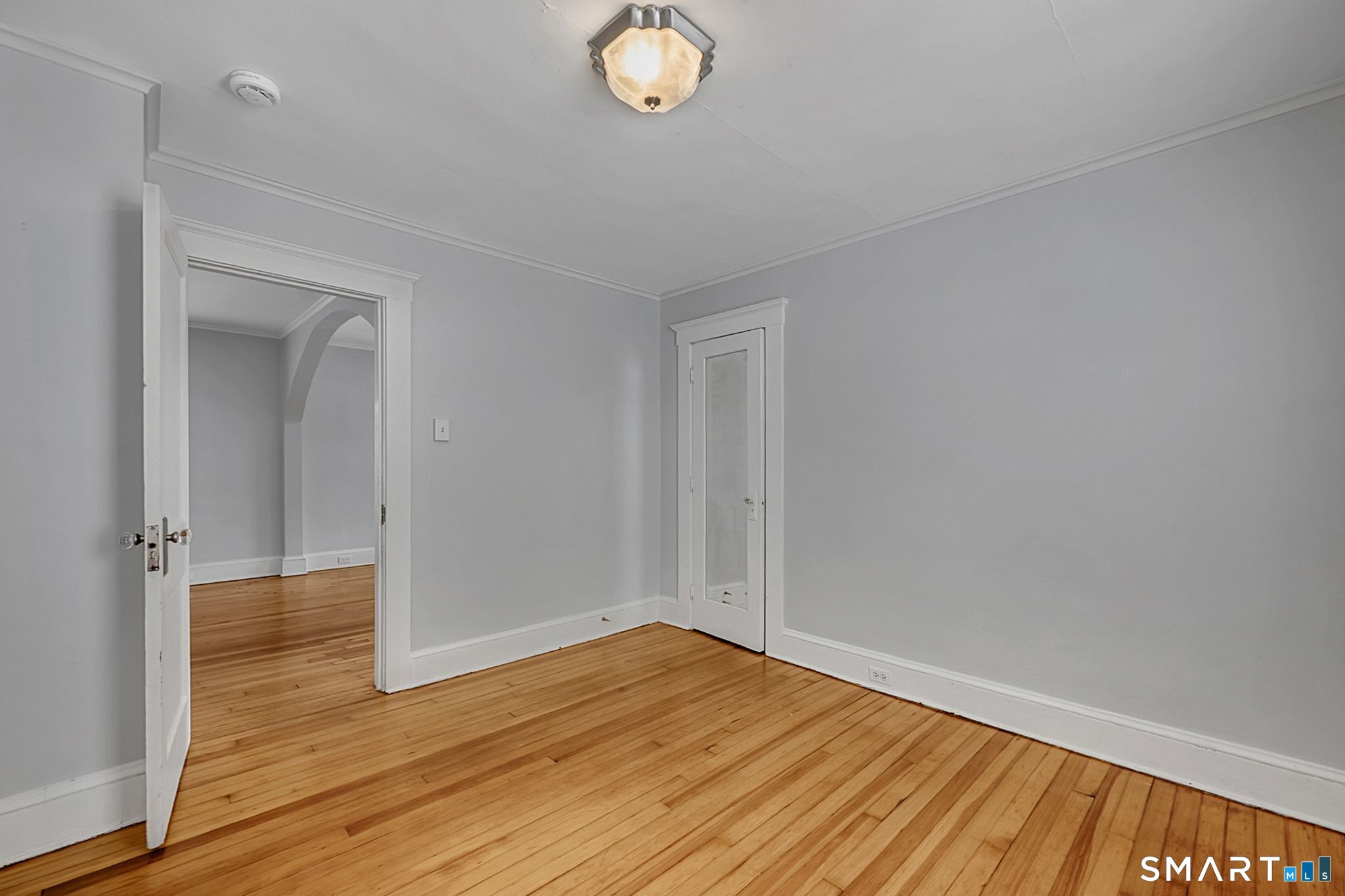 64 Cooper Street Torrington, CT 06790 - Photo 22 of 26 wooden floor in an empty room with a window