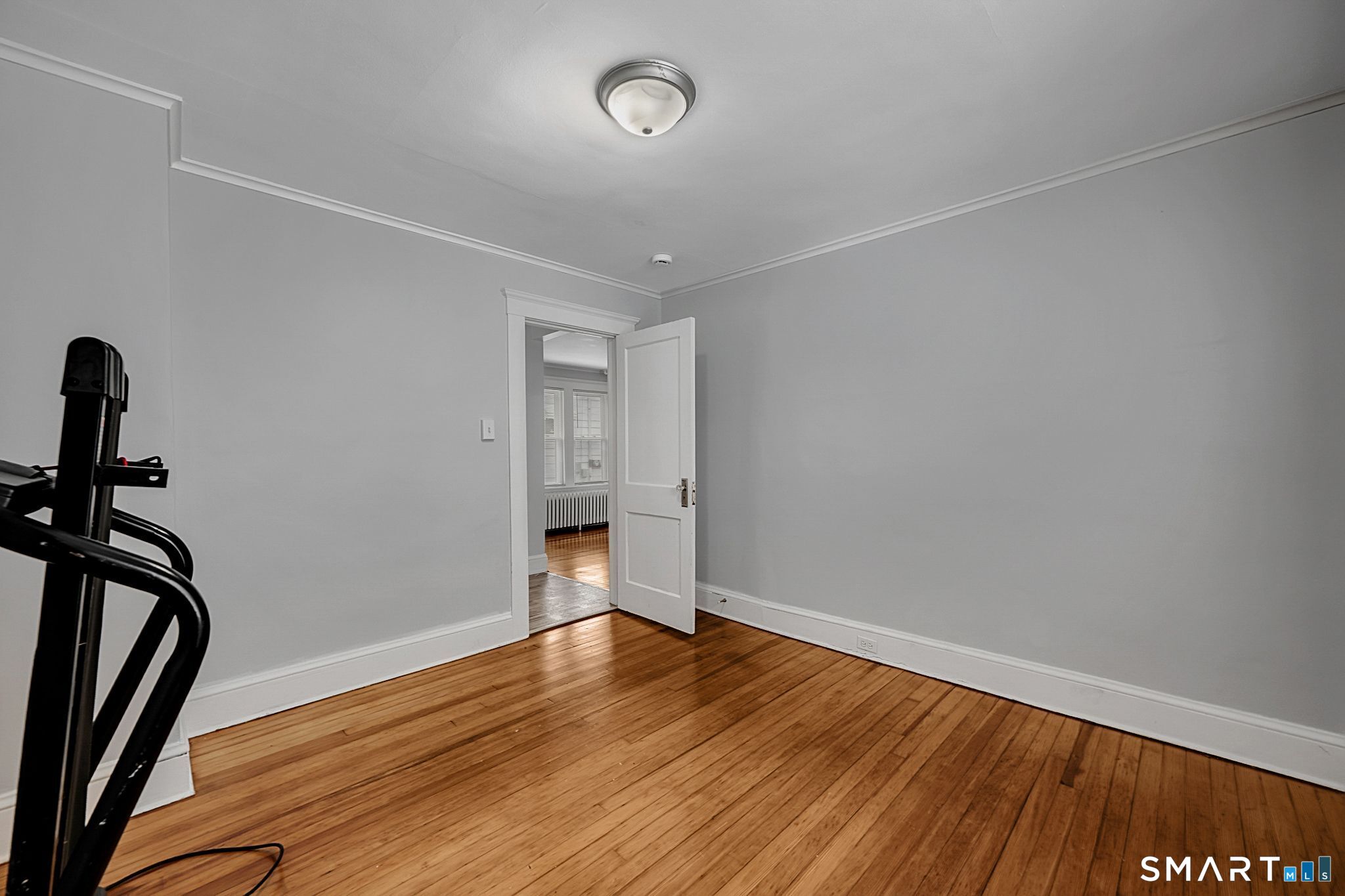 64 Cooper Street Torrington, CT 06790 - Photo 24 of 26 a view of empty room with wooden floor and fan