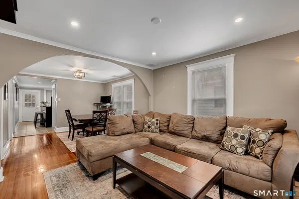 a living room with furniture and wooden floor