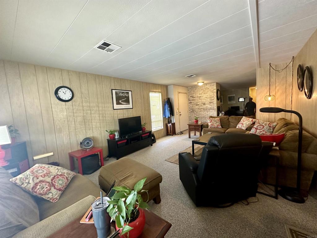 8301 Mission Gorge Road, Unit 194 Santee, CA 92071 - Photo 12 of 61 a living room with furniture and a flat screen tv
