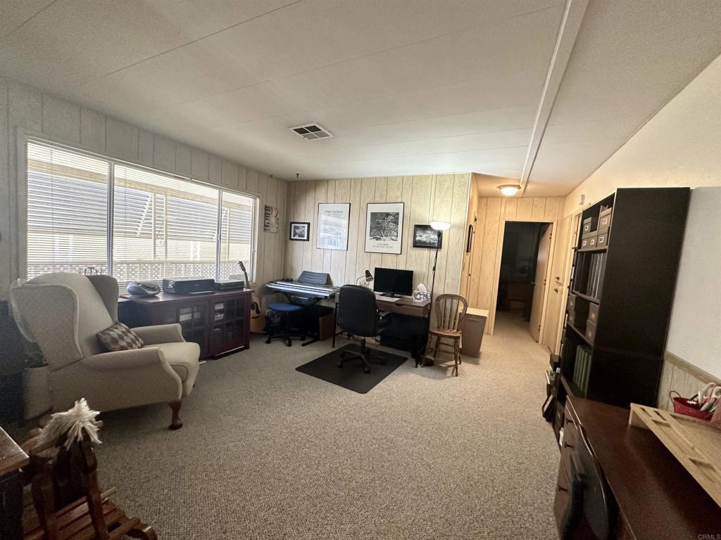 8301 Mission Gorge Road, Unit 194 Santee, CA 92071 - Photo 19 of 61 a living room with furniture gym equipment and a large window