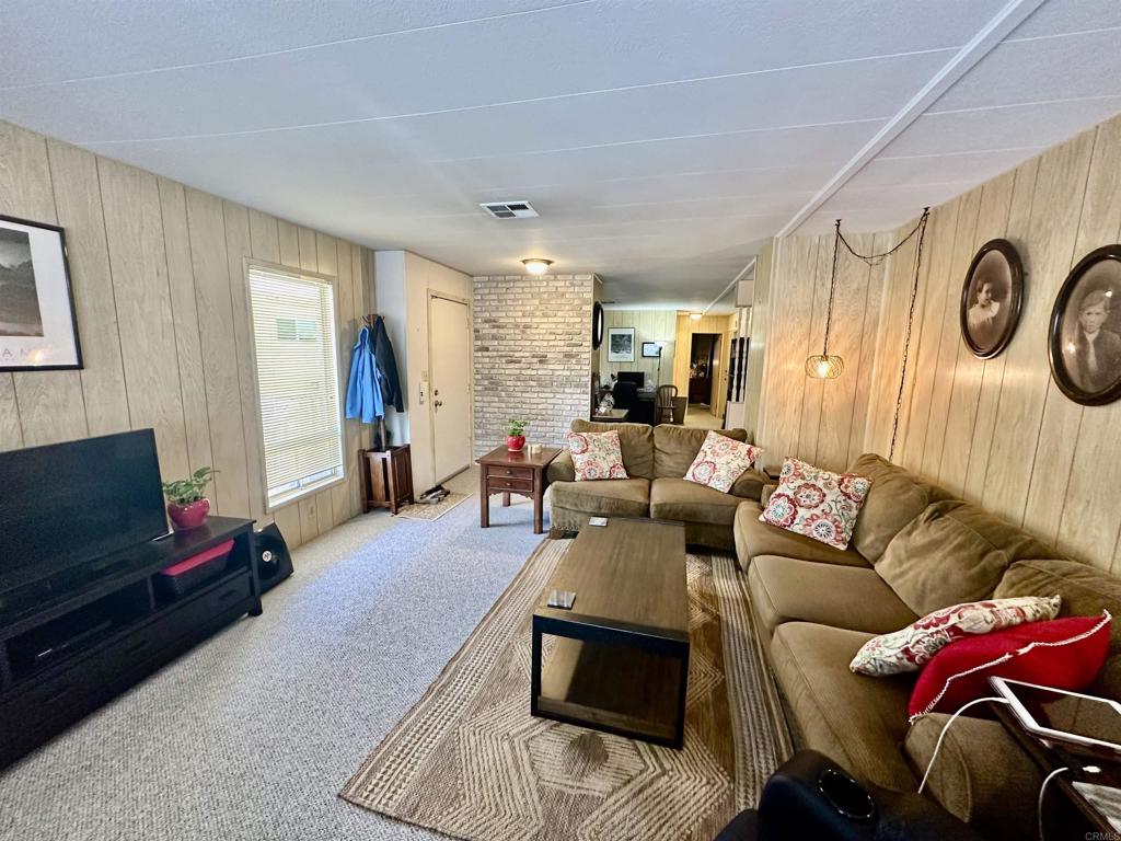 8301 Mission Gorge Road, Unit 194 Santee, CA 92071 - Photo 23 of 61 a living room with furniture and a flat screen tv