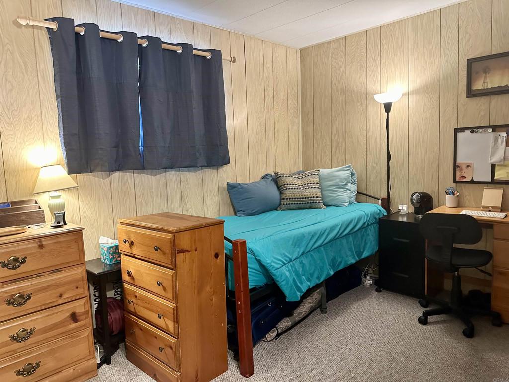 8301 Mission Gorge Road, Unit 194 Santee, CA 92071 - Photo 24 of 61 a bedroom with a bed and a mirror