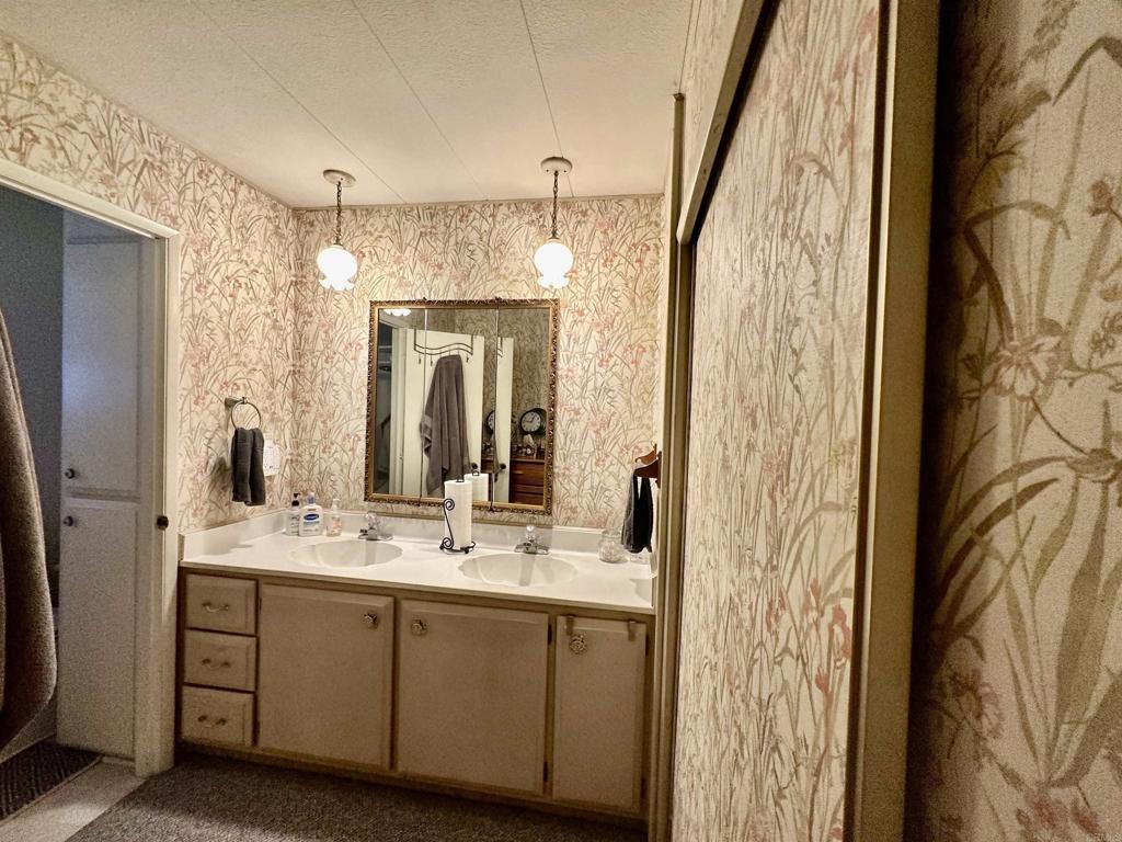 8301 Mission Gorge Road, Unit 194 Santee, CA 92071 - Photo 29 of 61 a bathroom with a double vanity sink mirror and shower