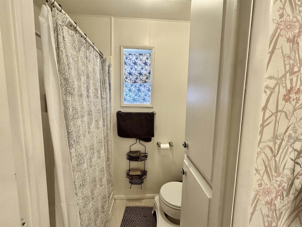 8301 Mission Gorge Road, Unit 194 Santee, CA 92071 - Photo 30 of 61 a bathroom with a toilet sink and shower curtain