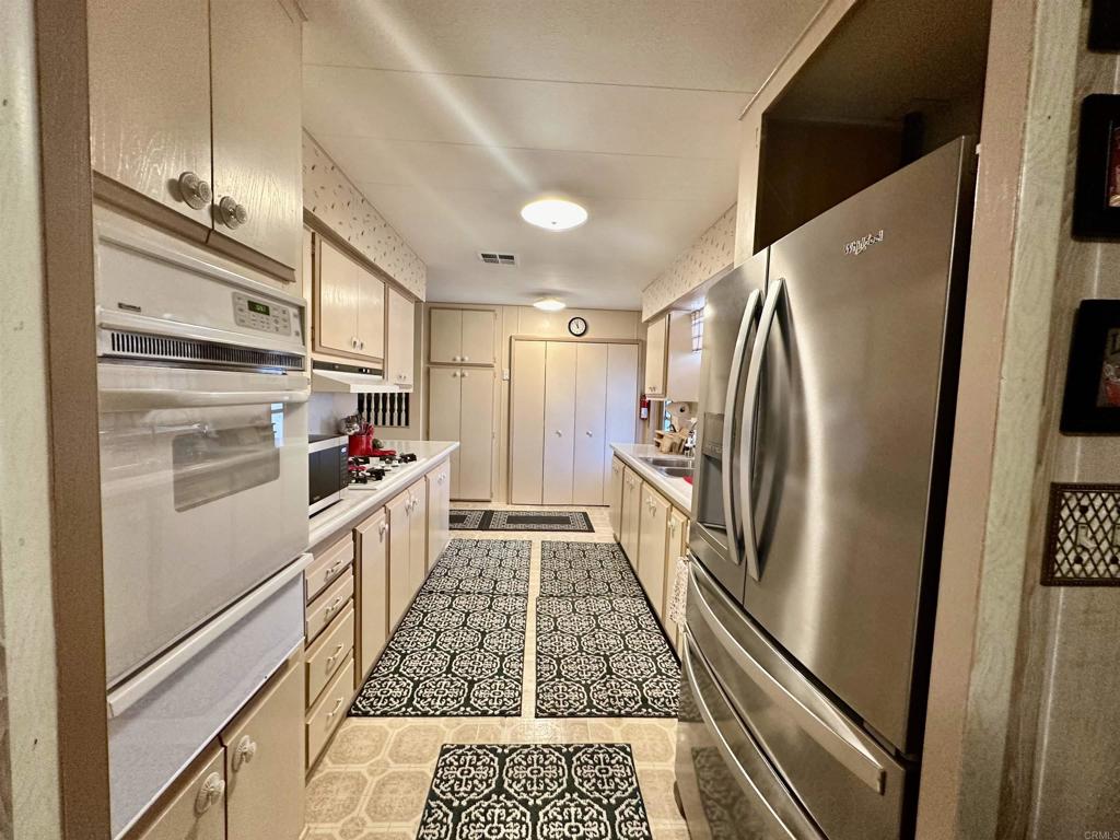 8301 Mission Gorge Road, Unit 194 Santee, CA 92071 - Photo 3 of 61 a kitchen with refrigerator a stove and a refrigerator