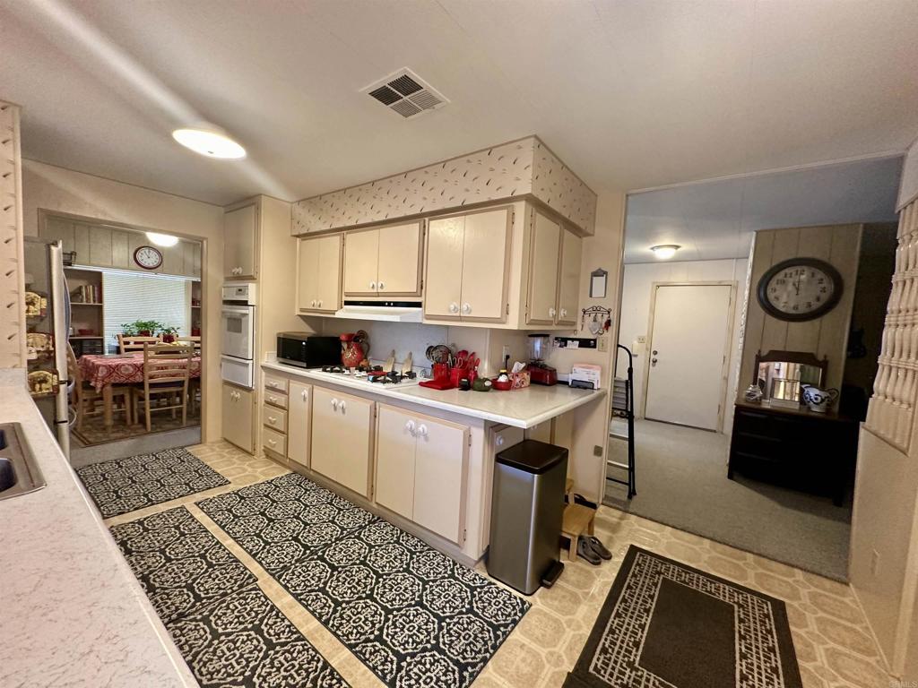 8301 Mission Gorge Road, Unit 194 Santee, CA 92071 - Photo 5 of 61 a kitchen with stainless steel appliances granite countertop a stove a sink and a refrigerator