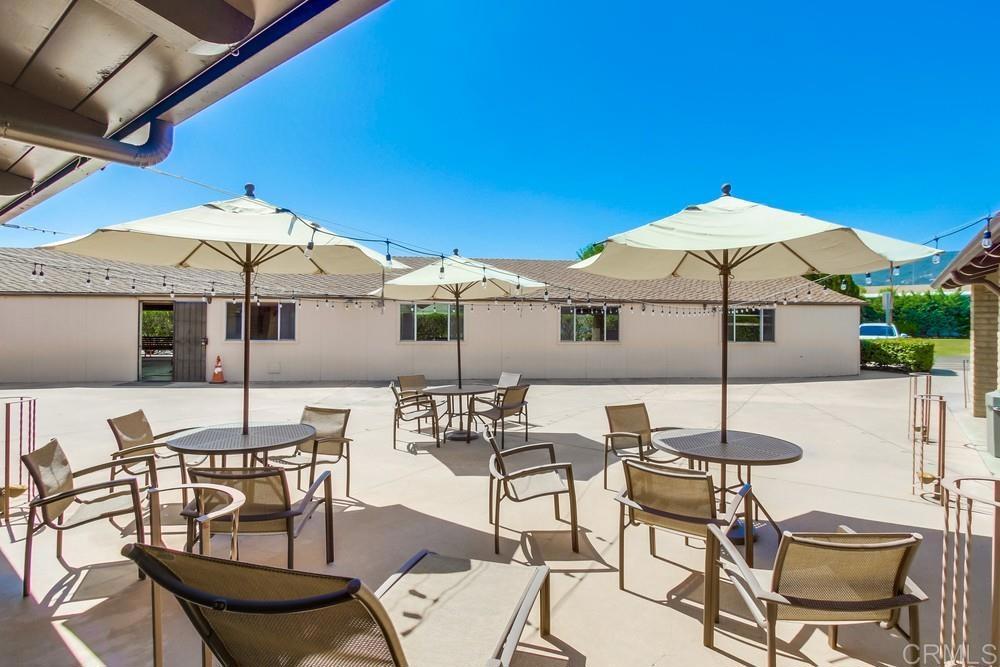 8301 Mission Gorge Road, Unit 194 Santee, CA 92071 - Photo 55 of 61 a patio with a table and chairs under an umbrella